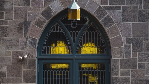 Fall leaves cover the steps outside a side door to Kirkpatrick Chapel
